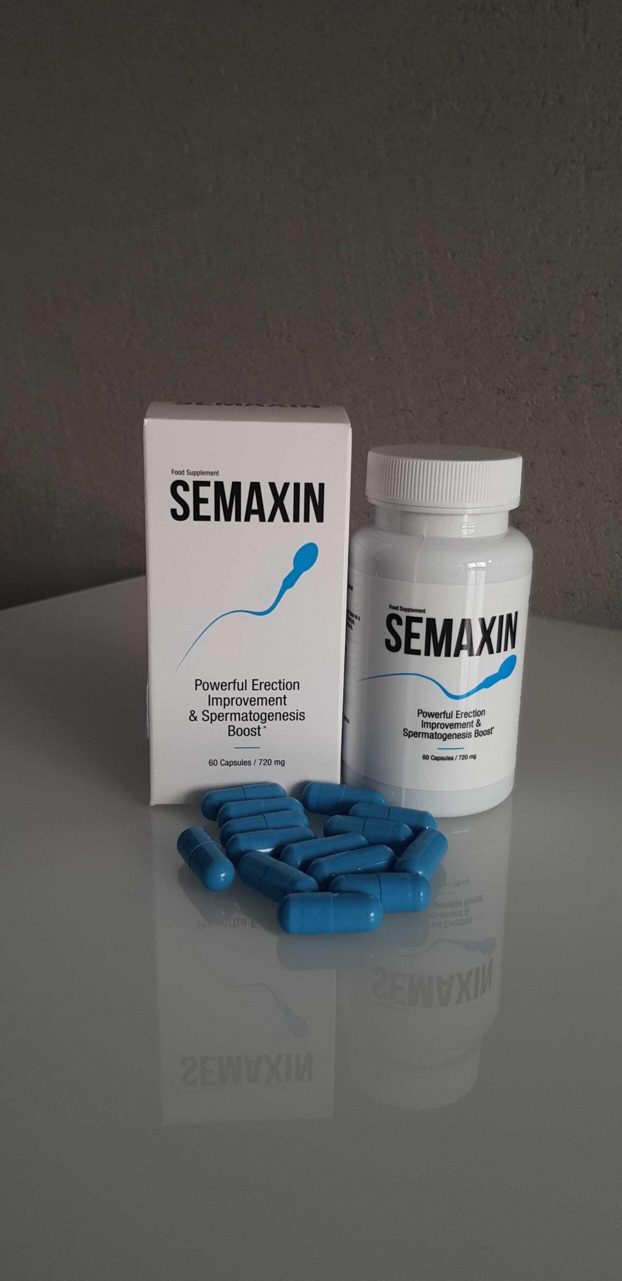 Semaxin 14 caja, bote y capsulas de color azul sobre superficie.